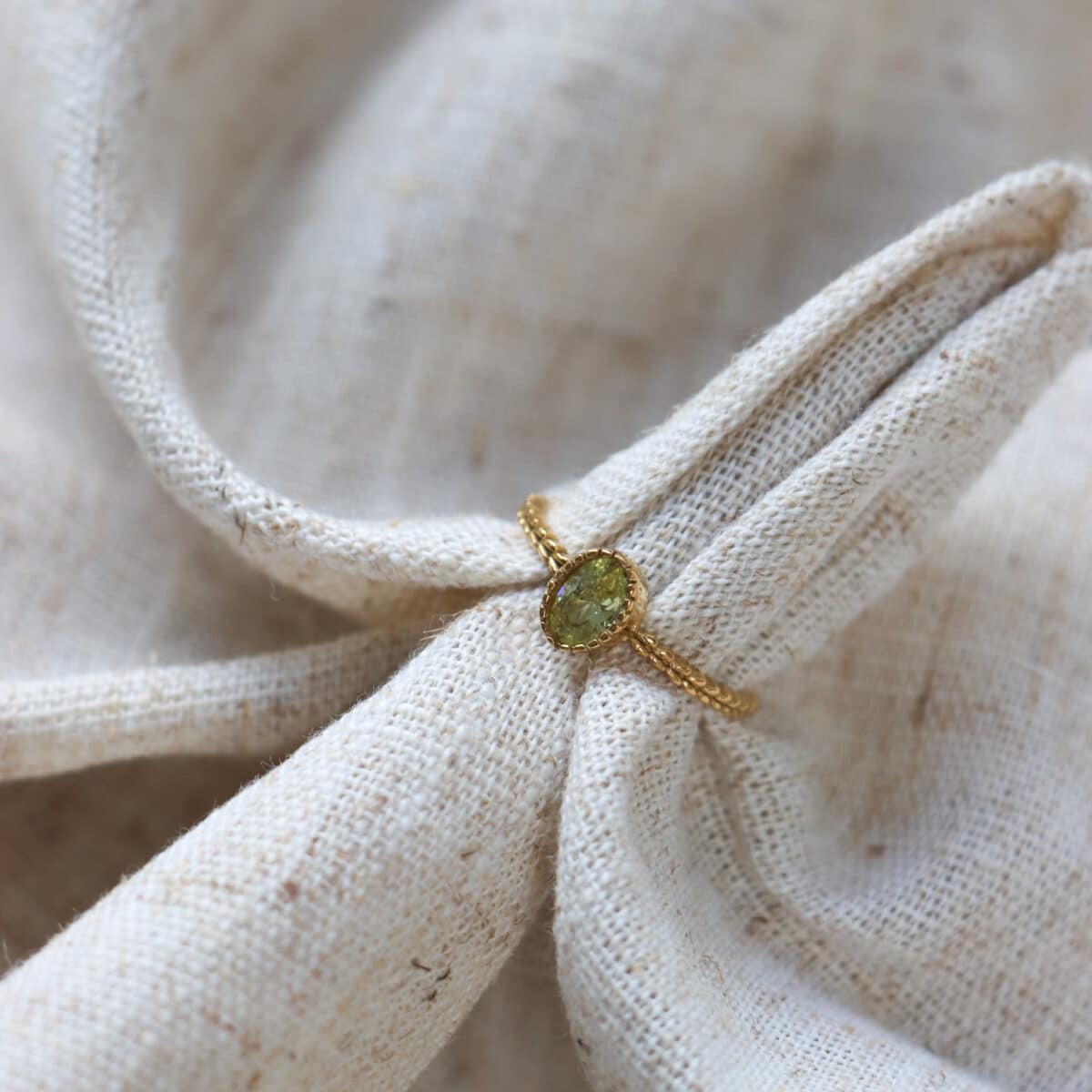 Braided green ring gold