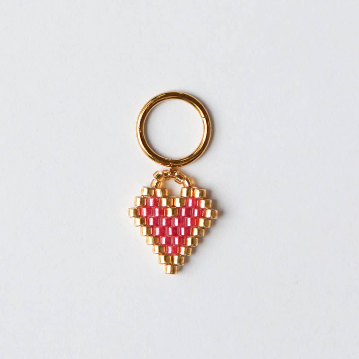 Dizzy pink heart charm gold